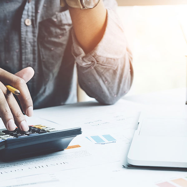 A Man with a Calculator performing Cost Analysis