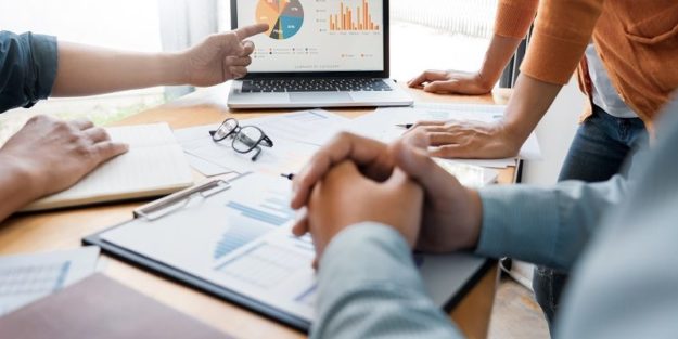 Business creative coworkers team Meeting Discussing showing the results chart and graph Work. How Can HOA Financial Management Services Benefit Your Community