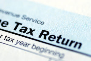 close up view of the income tax return document | homeowners association taxes