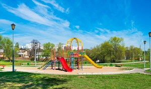 community playground on a bright sunny day | check HOA financial health