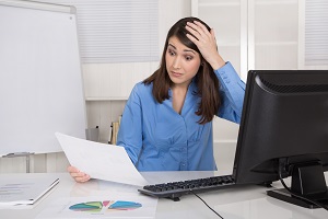 shocked woman with hand on head looking at document | hoa fraud