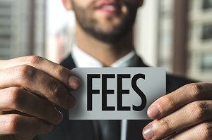 man in suit holding out paper with the word fees written on it | how much can hoa fees increase