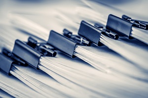close up of stack of office working document with paper clip folder | HOA records system