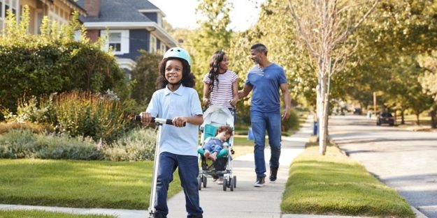 Couple Push Daughter In Stroller As Son Rides Scooter 4 Benefits Of Remote HOA Management Services