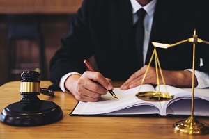 judge gavel, scale and a man in suit working on a documents | hoa cc&r documents