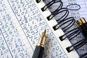 ledger and chart with numbers and pen | general ledger of an HOA