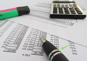 pen, calculator and highlighter over financial report | three parts of a balance sheet