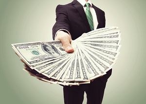 Business Man Displaying a Spread of Cash over a green vintage background | HOA financial management