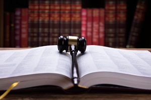 gavel on top of law book with books in shelf in the background | hoa reserve study