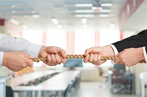 two business people holding rope in an office | hoa management company conflict of interest