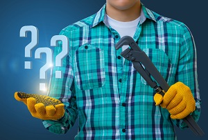 worker in a blue background with a spanner and questions in hand | capital improvements vs repairs and maintenance