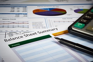 balance sheet summary and balance sheets with calculator and pen | HOA standard financial statements