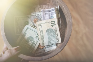 bowl filled with money bills | self-managed board budgeting