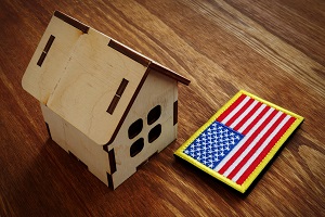 American flag and small house model | FHA-approved condo